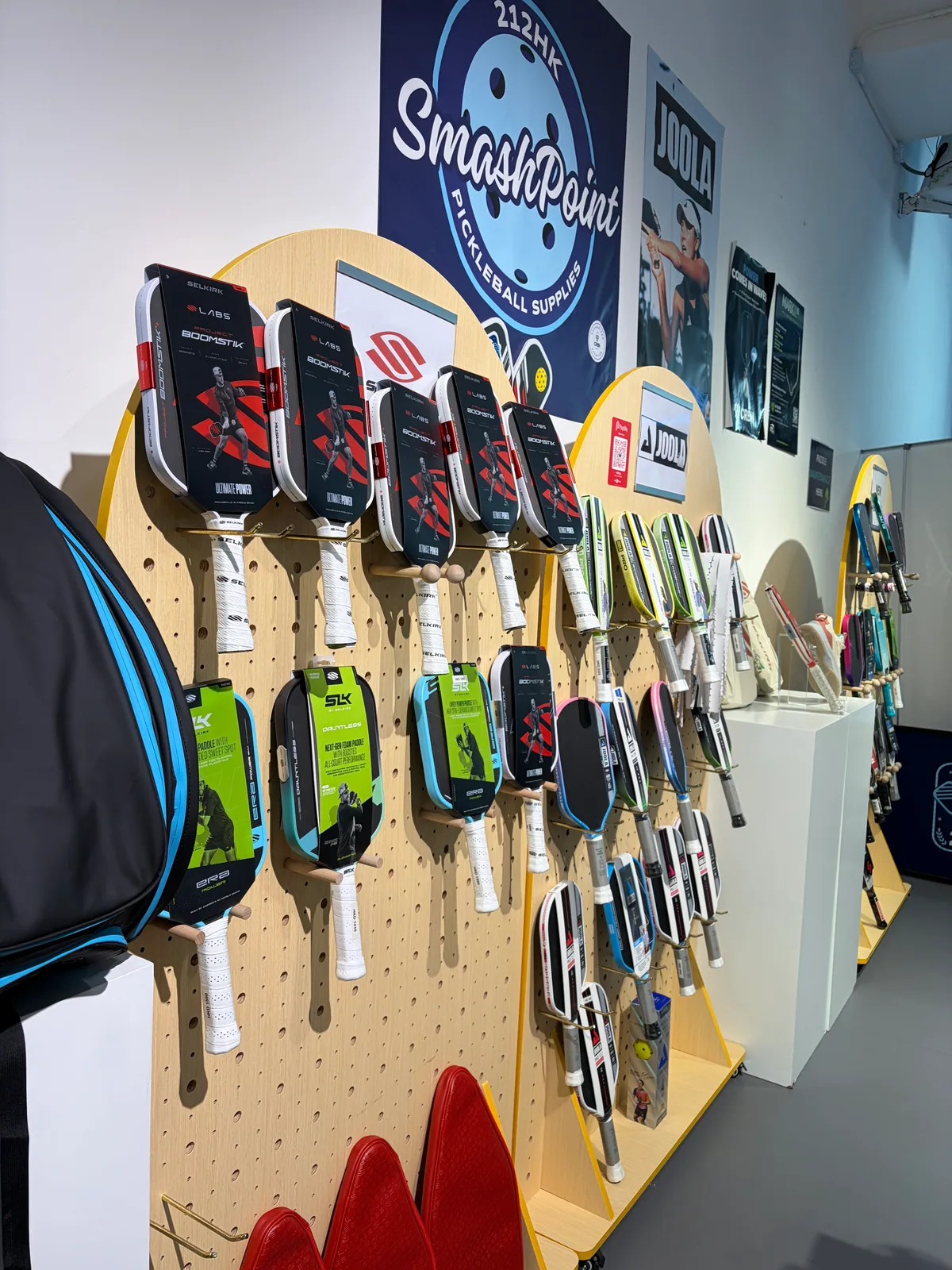Paddle display wall inside the SmashPoint pickleball shop at 212HK