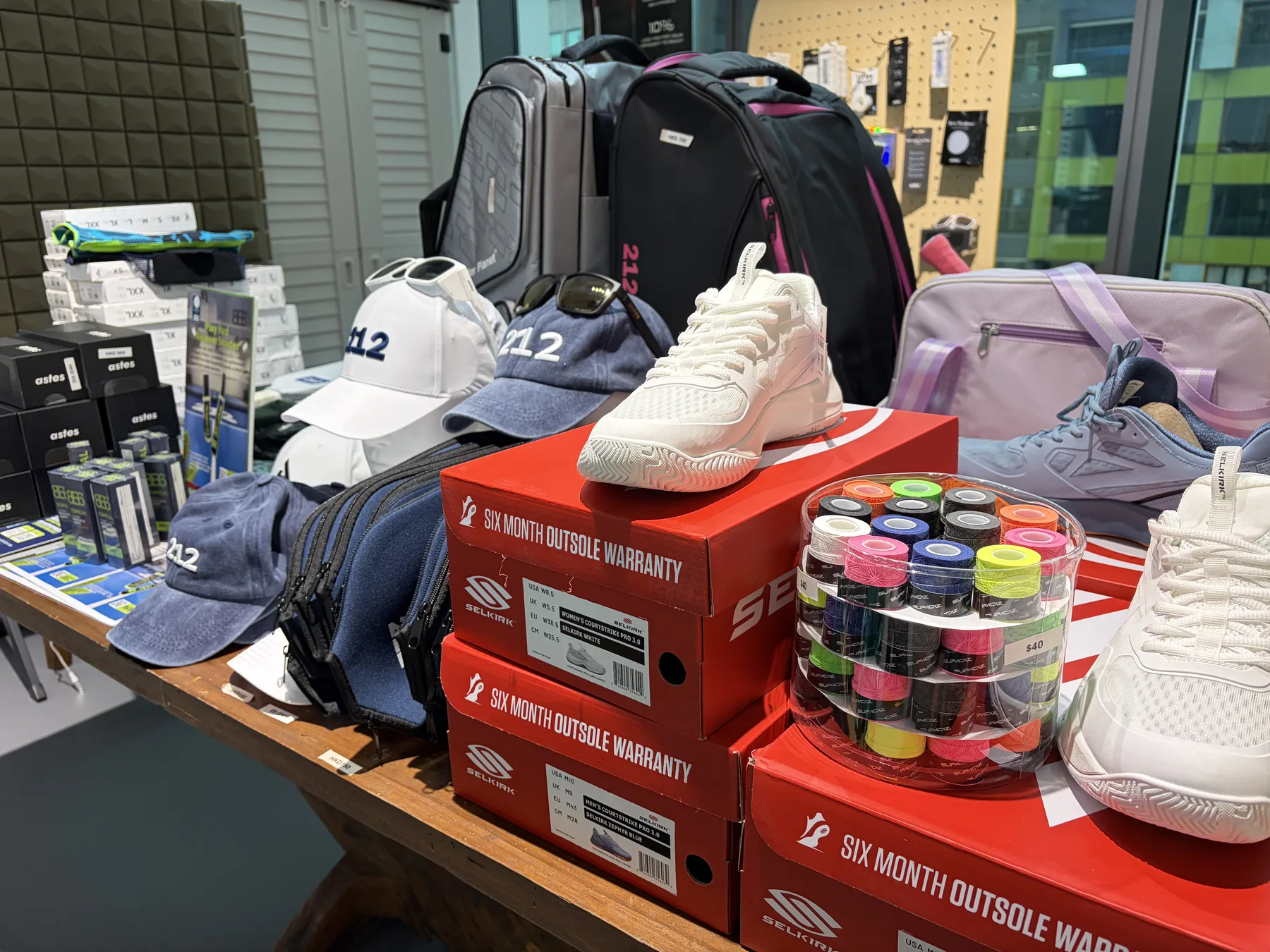 Selkirk shoes, grips, 212HK caps and bags displayed inside SmashPoint