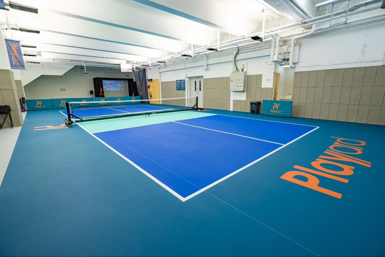 Blue PVC court with a teal kitchen and padded bumper walls