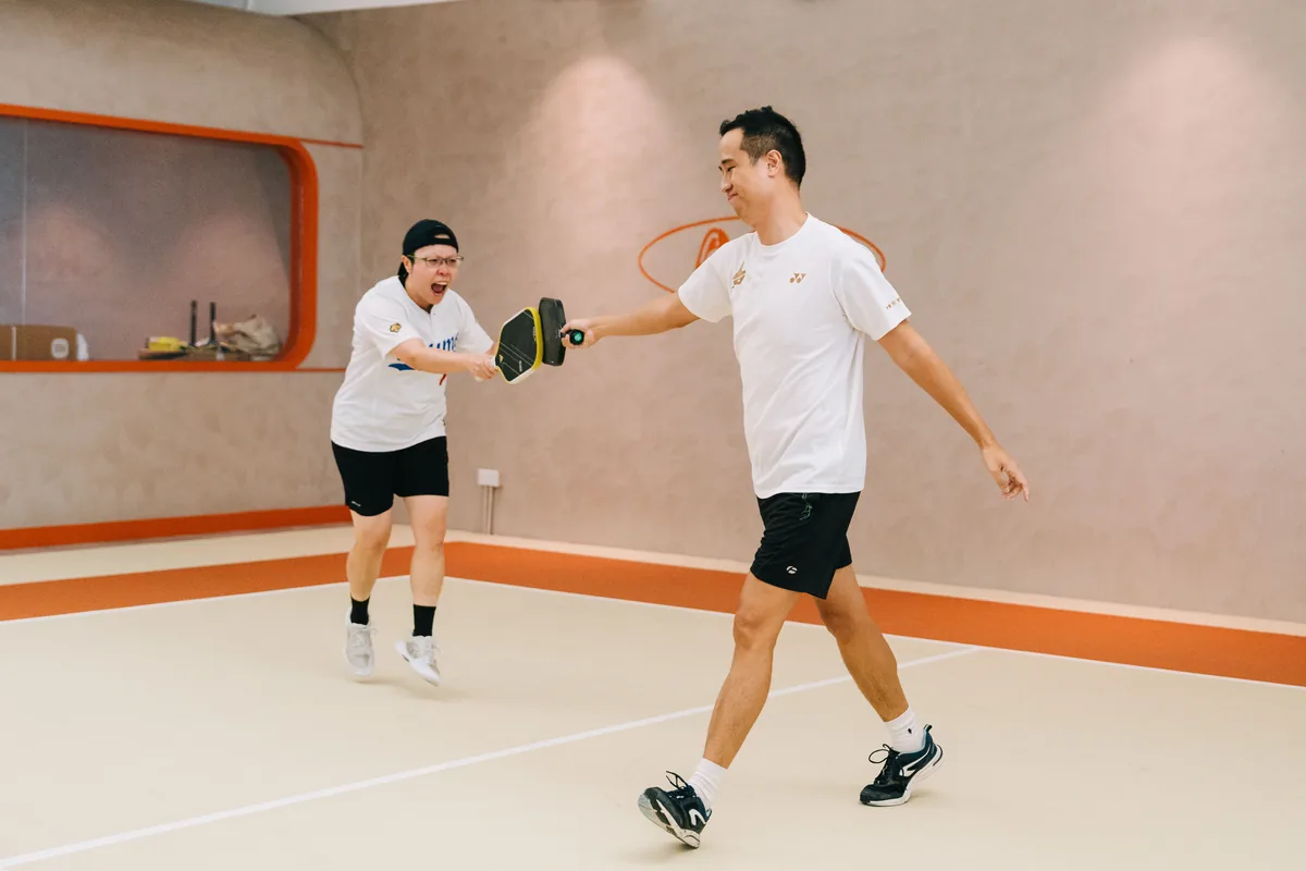 Players mid-rally on the flagship terracotta court